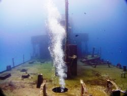 Bubbles from diver penetrating the wreck "Cañonero C53" a... by Kenn Bolbjerg 